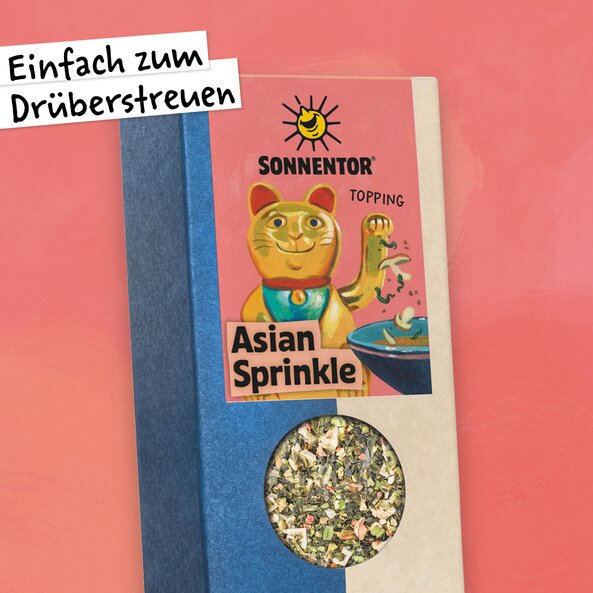 Asian Sprinkle Gewürz in der Packung mit Sichtfenster und Illustration einer winkenden Katze.